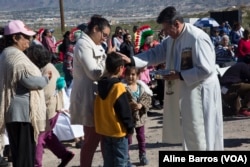 Children receiving blessings from a clergy man at the annual border mass on Saturday at the border fence in the Anapra area of Sunland Park, New Mexico.
