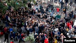 Migrants queue at the compound outside the Berlin Office of Health and Social Affairs (LaGeSo) as they wait for their registration in Berlin, Germany, Sept. 21, 2015. 