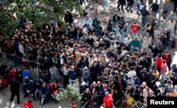 FILE - Migrants queue at the compound outside the Berlin Office of Health and Social Affairs (LaGeSo) as they wait for their registration in Berlin, Germany, Sept. 21, 2015.