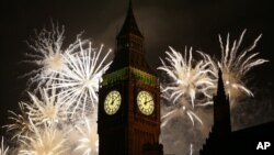 FILE - Fireworks explode over Elizabeth Tower housing the Big Ben clock to celebrate the New Year. The successful testing of a hyper-accurate clock could bring developments in physics and other areas of science.