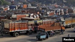 Trucks are seen parked in an open lot near a national highway on the outskirts of Ahmedabad, India, Dec. 2, 2015.