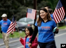 FILE - Christine Lui Chen, right, who is running for state senate during the November elections, walks with her daughter Lily Chen, 6, while participating in the Bridgewater Memorial Day Parade in Bridgewater, N.J., May 29, 2017.