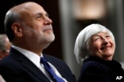 FILE - Federal Reserve Chair Janet Yellen, right, and former Federal Reserve Chair Ben Bernanke smile during introductions at a ceremony awarding them both with the Paul H. Douglas Award for Ethics in Government on Capitol Hill in Washington, Nov. 7, 2017.