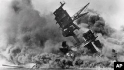 FILE - Smoke rises from the battleship USS Arizona on Dec. 7, 1941 as it sinks during the Japanese attack on Pearl Harbor, Hawaii. 