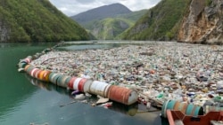 In this photo taken on Tuesday, April 23, 2019, plastic bottles and other garbage float in the river Drina near Visegrad, eastern Bosnia-Herzegovina. (AP Photo/Eldar Emric)