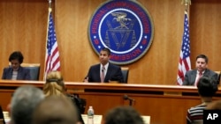 Federal Communications Commission Chairman Ajit Pai, center, announces the vote to repeal net neutrality, next to Commissioner Mignon Clyburn, left, who voted no, and Commissioner Michael O'Rielly, who voted yes, at the FCC, Dec. 14, 2017.