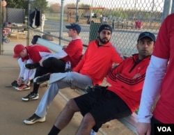 Danish Bashir, center, sits in the dugout at a softball game in Springfield, Virginia. (C. Presutti/VOA)