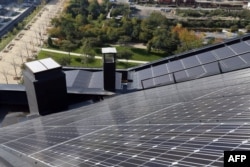 Panels of a photovoltaic power station are installed on the roof of a building in the new Clichy-Batignolles district in Paris, Oct. 22, 2012.