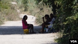 Three young women from Benin City wait in the shade of a lane for clients on the outskirts of Pozzuoli near Castel Volturno. The girls said they had been in Italy for two years. (J. Dettmer/VOA)