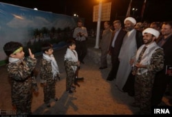 This photo posted on Iran's state-run news agency site IRNA purportedly shows a child going through a training session on how to use firearms.