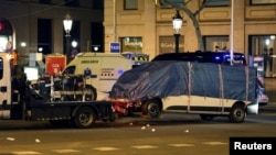 The suspected van is towed away from the area where it crashed into pedestrians at Las Ramblas in Barcelona, Spain, Aug. 18, 2017.