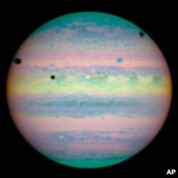 Hubble's image of three moons casting shadows on Jupiter