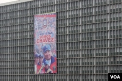 A government building in Caracas displays a poster with an image of the late Venezuelan President Hugo Chavez, Apr. 11, 2013.