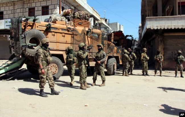 Turkish soldiers, positioned in the city center of Afrin, northwestern Syria, March 19, 2018, a day after they took the control of the area.