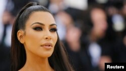 FILE - Kim Kardashian West arrives at the Metropolitan Museum of Art Costume Institute Gala (Met Gala) to celebrate the opening of “Heavenly Bodies: Fashion and the Catholic Imagination” in the Manhattan borough of New York, U.S., May 7, 2018. 
