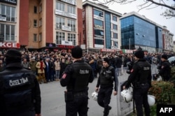 Turkish anti-riot police officers stand guard as people gather outside Bakirkoy courthouse in Istanbul, Jan. 12, 2018, in support of the jailed co-chair of the People's Democratic Party (HDP).