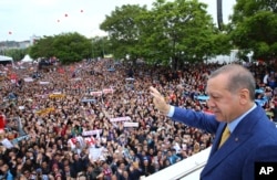 FILE - Turkey's President Recep Tayyip Erdogan waves to supporters as he arrives for a congress of the ruling Justice and Development Party (AKP) in Ankara, May 21, 2017.