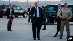 President Donald Trump gives a thumbs up as he arrives at McCarran International Airport for a campaign rally, Sept. 20, 2018, in Las Vegas.