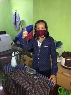 Seorang transpuan mencuci dan menyetrika pakaian di FKWI Laundry di Depok. (foto: courtesy)