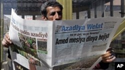 A man reads a Kurdish newspaper in southeastern city of Diyarbakir, Turkey, March 22, 2009.