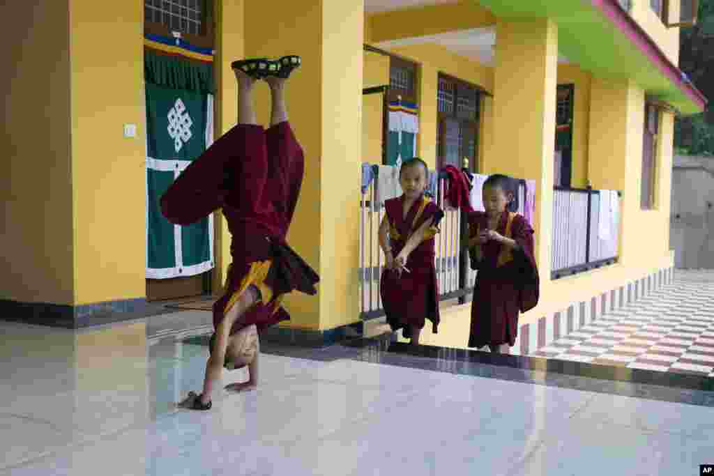 Nine-year-old Tenzin Kunphen performs a somersault during lunch break at Namgyal Monastery School in Dharmsala, India, July 9, 2018.