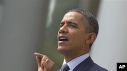 President Barack Obama gestures while speaking in the Rose Garden of the White House in Washington, DC, September 19, 2011.