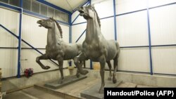 Horse sculptures "Walking Horses" by Austrian-German sculpturer Josef Thorak are shown in a police warehouse in Bad Bergzabern, central Germany, made available May 22, 2015. 