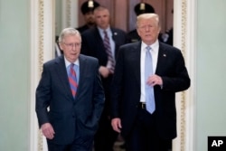 FILE - President Donald Trump, accompanied by Senate Majority Leader Mitch McConnell of Kentucky, left, arrives for a Senate Republican Policy lunch on Capitol Hill in Washington, May 15, 2018.