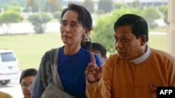 FILE - Myanmar democracy icon Aung San Suu Kyi (L) is escorted by National League for Democracy (NLD) senior leader and lawmaker Zaw Myint Maung (R) as she arrives at the parliament in Naypyidaw, March 1, 2016. 