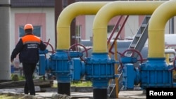 An employee walks past gas pipes at Oparivske gas underground storage in the Lviv region, Ukraine, Sept. 30, 2014.