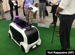 In this Thursday, July 18, 2019, photo, a "field support robot" is demonstrated before the media at Toyota Motor Corp. headquarters in Tokyo.