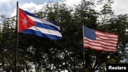 FILE - Flags of Cuba and the U.S. flutter in Havana, Cuba, Dec. 19, 2014. 
