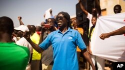 FILE - A man shouts as he and others gather at the Place de Nation calling for a civilian democratic transition in Ouagadougou, Burkina Faso, Nov. 2, 2014.