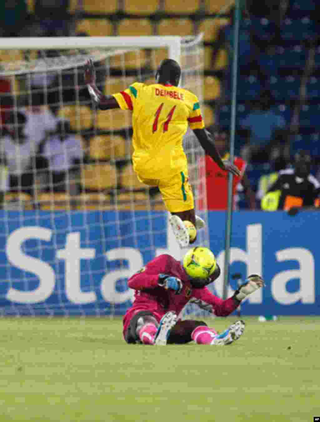 Guinea's goalkeeper Naby Yattara makes a save from Mali's Garra Dembele during their African Nations Cup Group D soccer match at Franceville Stadium