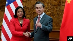 U.S. National Security Advisor Susan Rice, left, shakes hand with Chinese Foreign Minister Wang Yi at the Olive Hall before a meeting at the Foreign Ministry office in Beijing, China Tuesday, Sept. 9, 2014. China and the U.S. need to avoid incidents that
