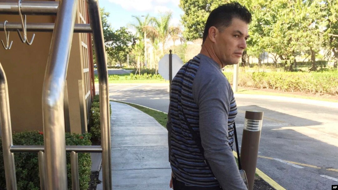 FILE - Luis Alberto Rodriguez, 43, waits for a friend to pick him up from temporary housing in Miami, Jan. 13, 2017.