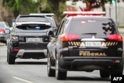 A convoy transporting imprisoned former Brazilian president Luiz Inacio Lula Da Silva, leaves the federal court in Curitiba, Brazil, Nov. 14, 2018.