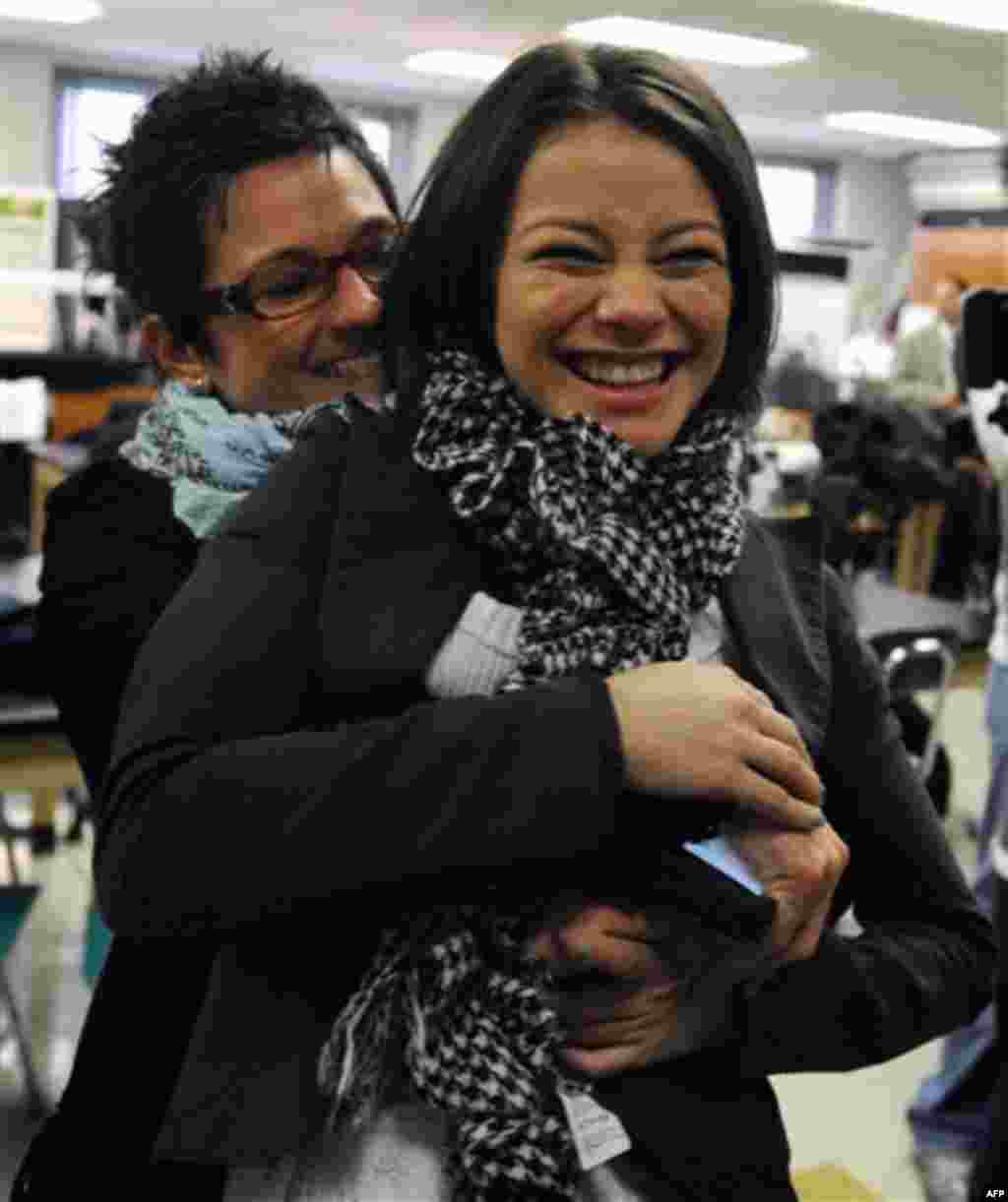 Intel Semifinalist Samantha Garvey, 17, right, gets a hug from her science research teacher, Rebecca Grella, left, after an announcement by Suffolk County officials, Friday, Jan. 13, 2012, at Brentwood High School in Brentwood, NY. Garvey and her family