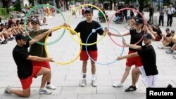 FILE - Participants perform during an event organized by Kosovo's National Olympic Committee in the capital Pristina.