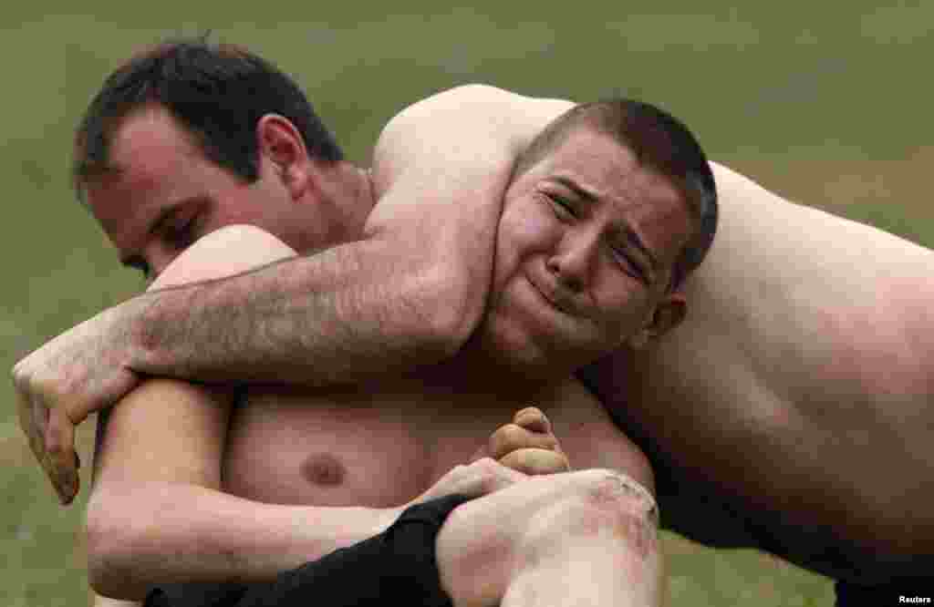 Men take part in a traditional wrestling competition in the village of Draginovo in the Rhodope mountains, southeast from the Bulgarian capital Sofia.