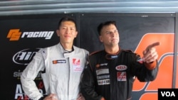 Race car drivers Sunny Wong and Pete Olson promote the charity the Child Fund in Zhuhai, China, Sept. 15, 2013. (Marianne Brown for VOA)