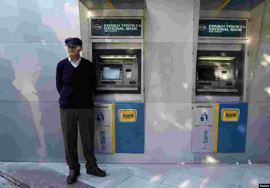A pensioner waits outside a branch of the National Bank of Greece hoping to get his pension, in Thessaloniki, Greece, June 29, 2015. 