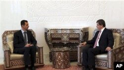 Turkish Foreign Minister Ahmet Davutoglu, right, meets with Syrian President Bashar al-Assad in Damascus. The regime faces a chorus of global reproach, with envoys from many countries pressing for an end to the violent crackdown.