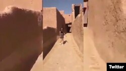 This screen grab of a video posted online purports to show a woman wearing a miniskirt and crop top at a historic fort in Ushaiager, Saudi Arabia.