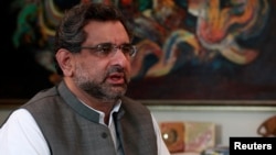 FILE - Pakistan's Petroleum and Natural Resources Shahid Khaqan Abbasi speaks during an interview at his office in Islamabad, Pakistan, Nov. 8, 2013. Abbasi is to succeed ousted Prime Minister Nawaz Sharif for a short term of 45 days.