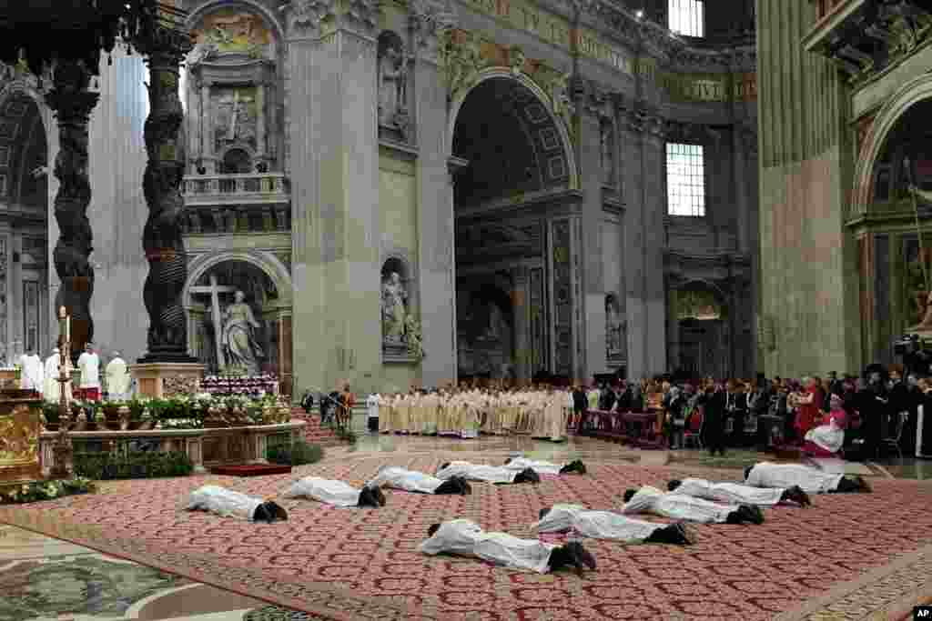 Ten new priests who were ordained by Pope Francis lay on the ground during a ceremony in St. Peter&#39;s Basilica at the Vatican.