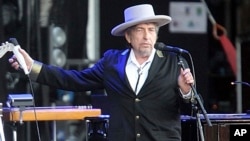 FILE - This July 22, 2012, photo shows U.S. singer-songwriter Bob Dylan performing onstage at "Les Vieilles Charrues" Festival in Carhaix, western France.