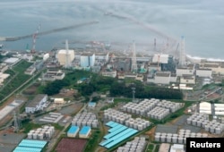 An aerial view shows the tsunami-crippled Fukushima Daiichi nuclear power plant and its contaminated water storage tanks in this photo taken by Kyodo, August 20, 2013.