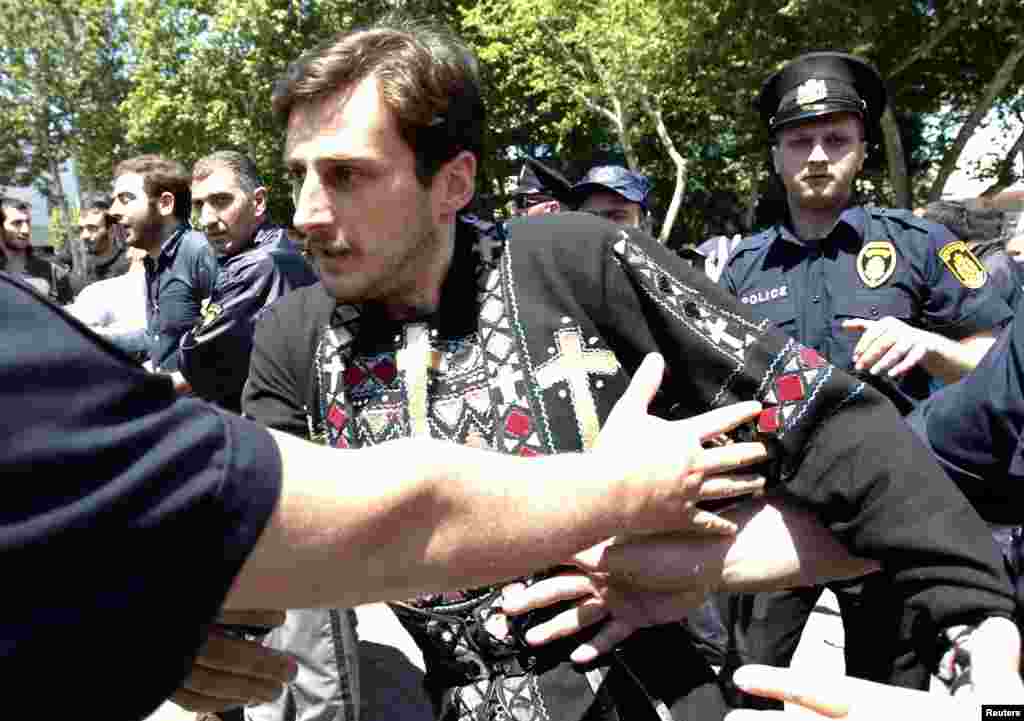 Police try to stop an Orthodox Christian activist during clashes at an International Day Against Homophobia and Transphobia rally in Tbilisi, May 17, 2013. 