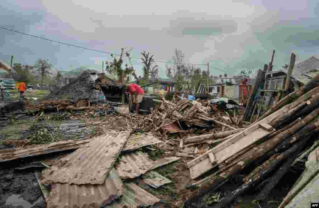 This handout photo taken and received on March 15, 2015 by UNICEF Pacific shows scattered debris outside local homes after the area was badly damaged by Cyclone Pam, outside the Vanuatu capital of Port Vila.